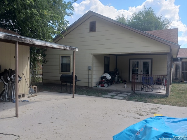 back of property featuring french doors and a patio area