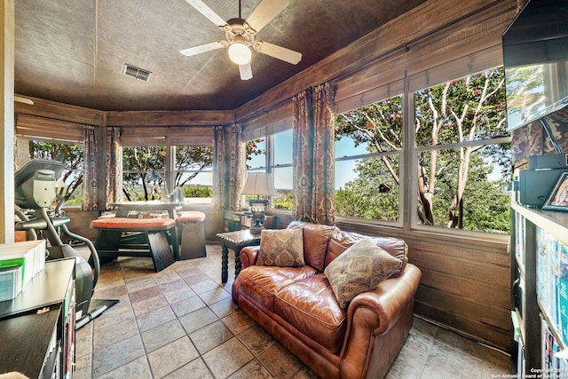 sunroom / solarium featuring ceiling fan