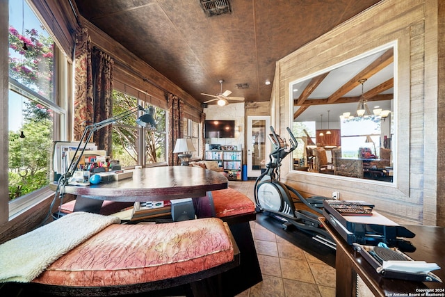 sunroom / solarium featuring ceiling fan with notable chandelier