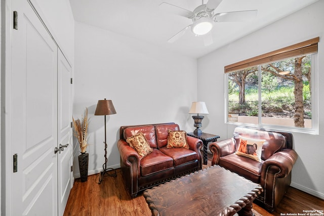 living area with dark hardwood / wood-style flooring and ceiling fan