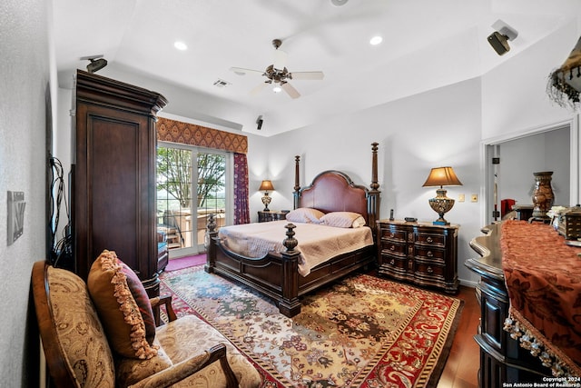 bedroom with vaulted ceiling, ceiling fan, dark hardwood / wood-style floors, and access to outside