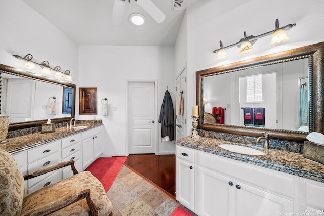 bathroom featuring ceiling fan, vanity, lofted ceiling, and hardwood / wood-style flooring