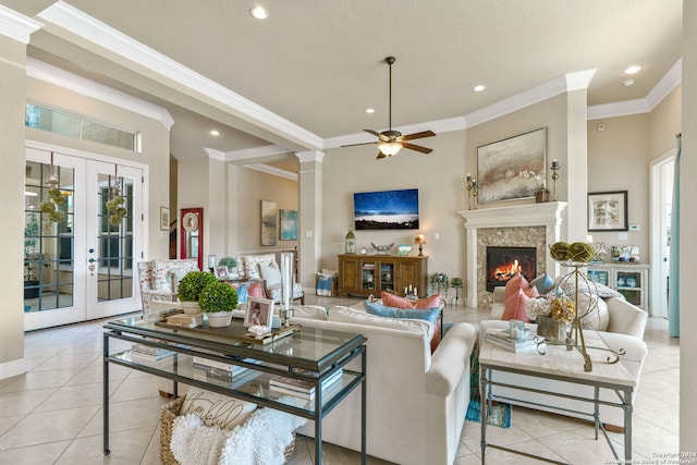 tiled living room featuring french doors, ornamental molding, and ceiling fan