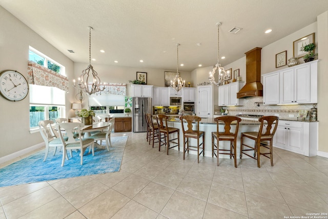 tiled dining room featuring a textured ceiling