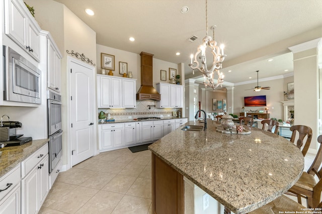 kitchen featuring a kitchen breakfast bar, stainless steel appliances, and a large island