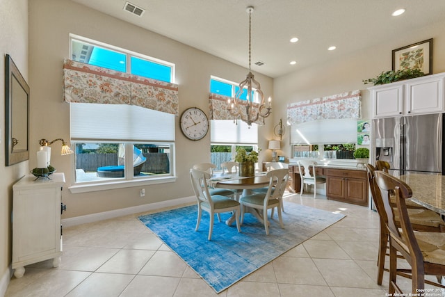 tiled dining area featuring an inviting chandelier