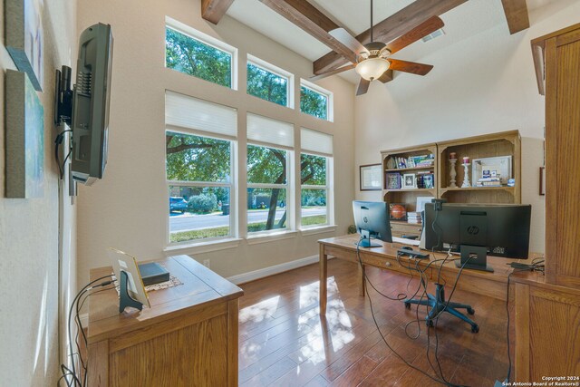 office area featuring ceiling fan, beam ceiling, light hardwood / wood-style flooring, and a healthy amount of sunlight