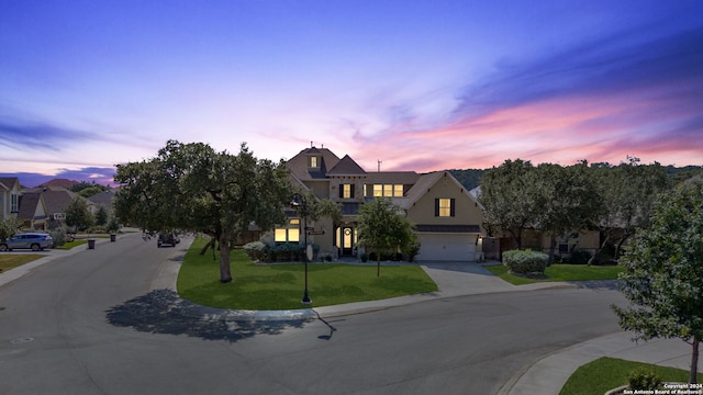 view of front of property featuring a yard and a garage