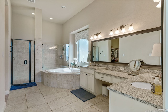 bathroom featuring independent shower and bath, vanity, and tile patterned floors