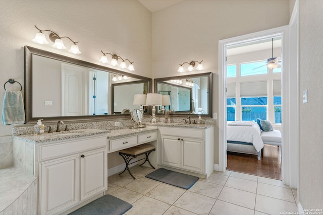 bathroom with tile patterned floors, vanity, and ceiling fan