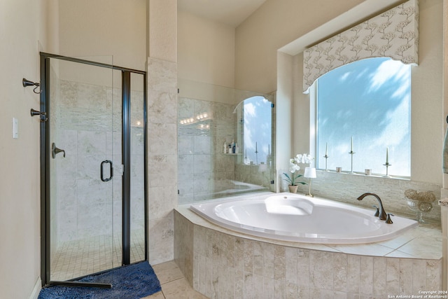 bathroom featuring tile patterned flooring and plus walk in shower