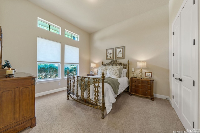 carpeted bedroom featuring multiple windows