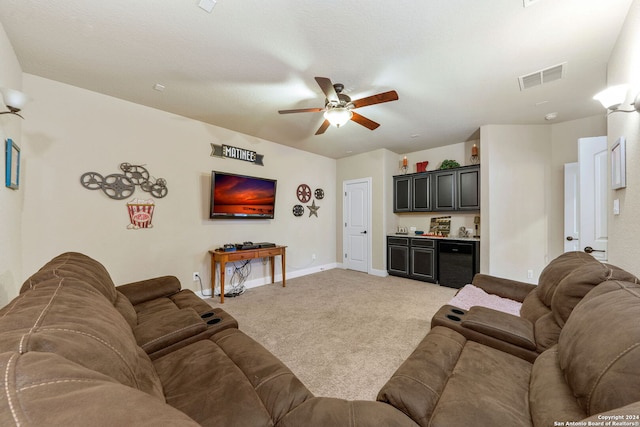 living room with bar area, light carpet, and ceiling fan