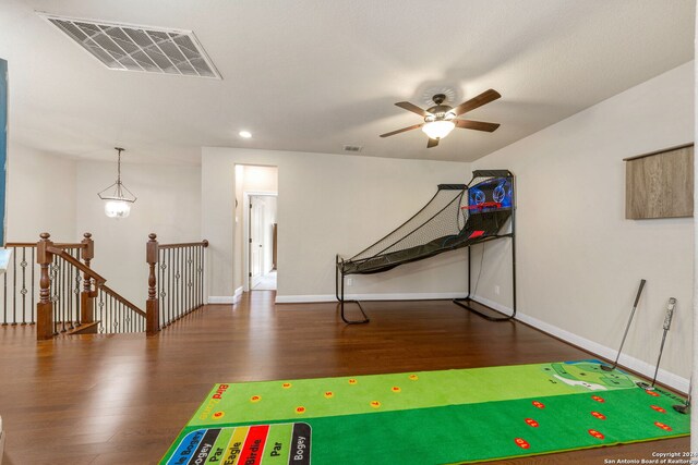 rec room with ceiling fan and dark wood-type flooring