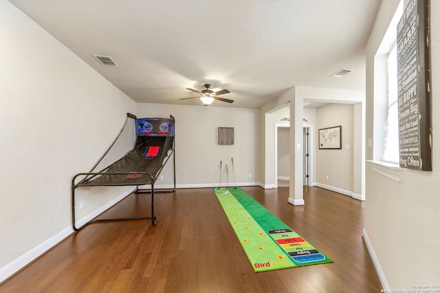 recreation room featuring ceiling fan and dark hardwood / wood-style floors