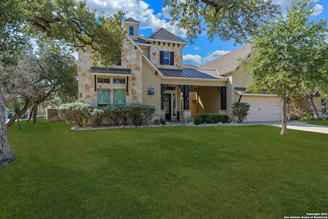 view of front of property with a garage and a front lawn