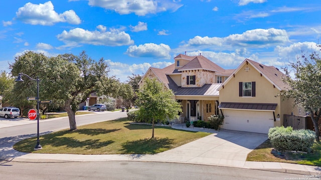 view of front of home with a garage and a front yard