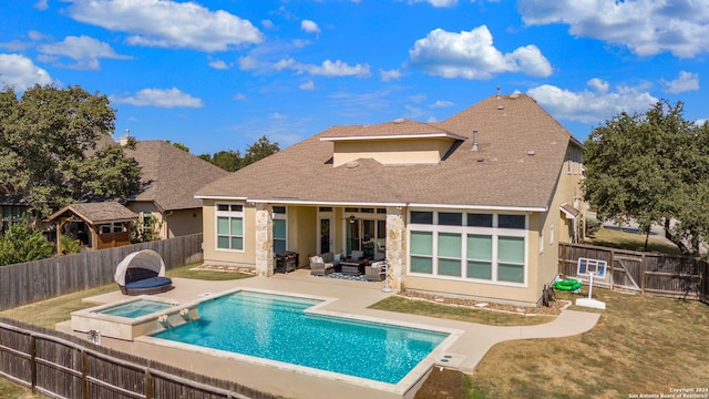 back of house featuring a patio, a yard, a swimming pool with hot tub, and an outdoor living space