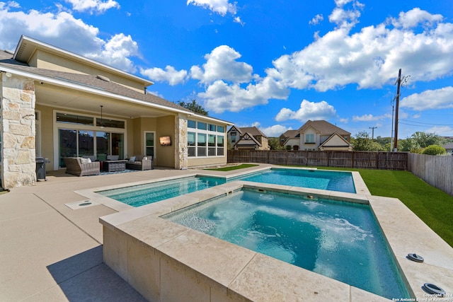 view of pool with ceiling fan, an outdoor hangout area, a yard, a patio, and an in ground hot tub