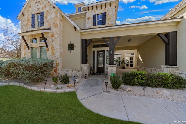 doorway to property with a yard