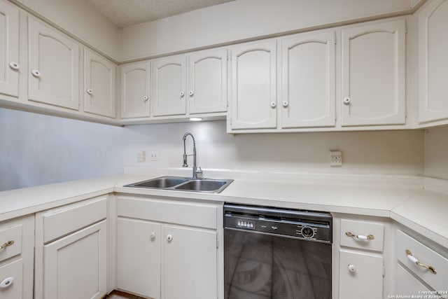 kitchen featuring a textured ceiling, white cabinetry, dishwasher, and sink