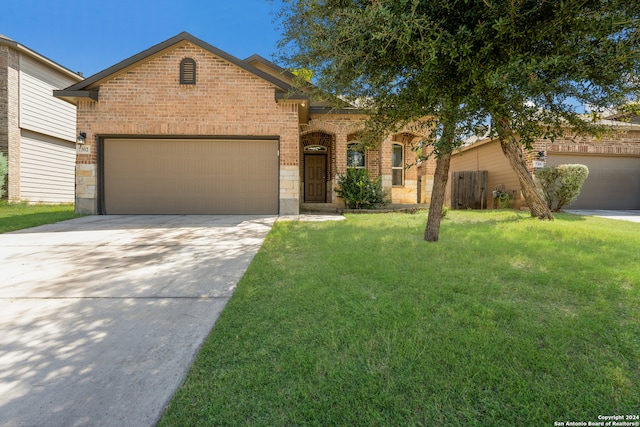 view of front of property with a garage and a front lawn