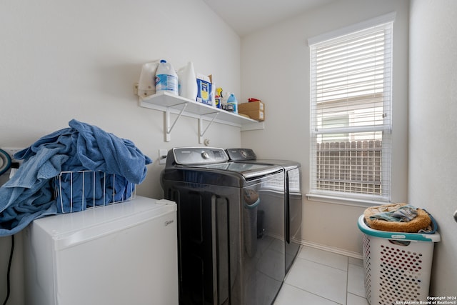 washroom with light tile patterned floors and washing machine and clothes dryer