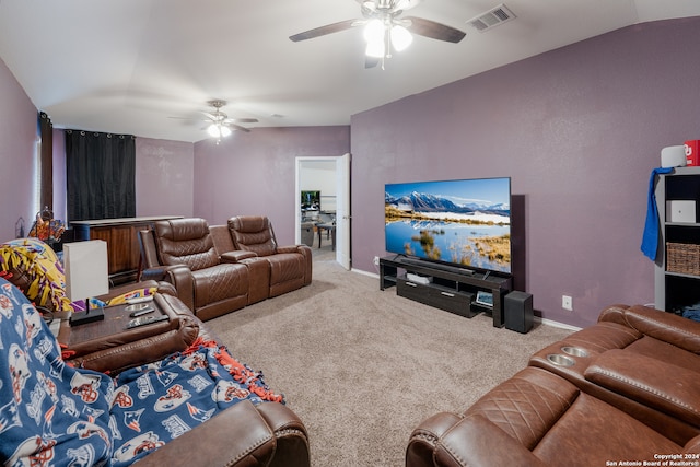 living room featuring ceiling fan, carpet floors, and lofted ceiling