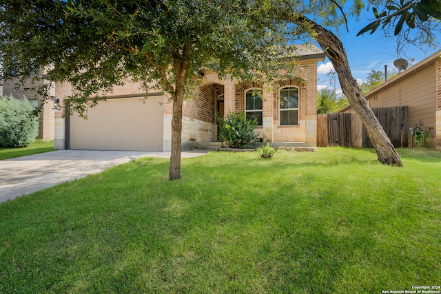 view of front of house featuring a front lawn and a garage