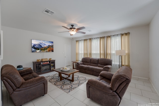 living room featuring ceiling fan and light tile patterned floors