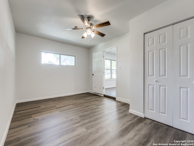 unfurnished bedroom featuring dark hardwood / wood-style floors and multiple windows