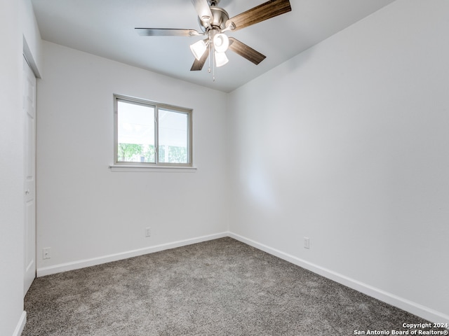 carpeted empty room featuring ceiling fan