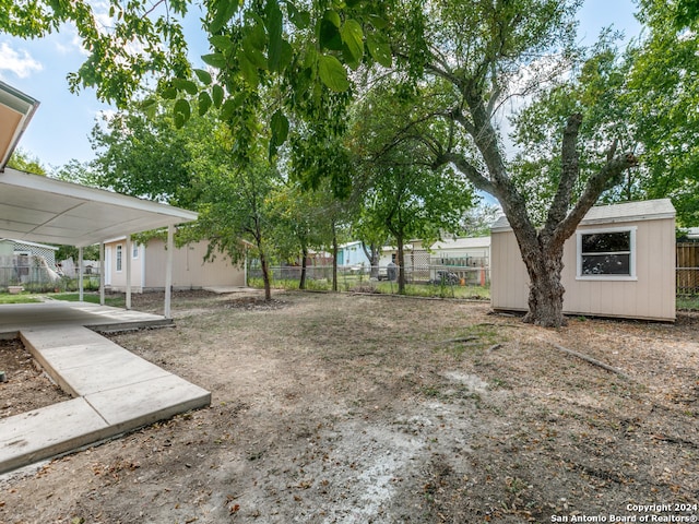 view of yard featuring a patio and an outdoor structure