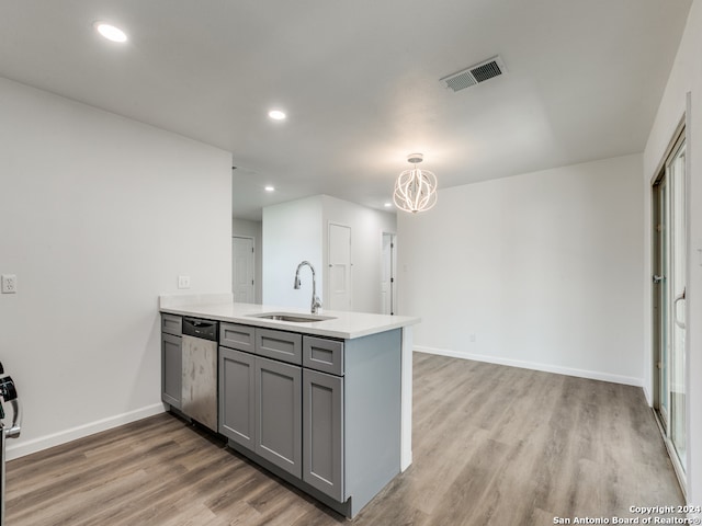 kitchen featuring sink, kitchen peninsula, light hardwood / wood-style flooring, gray cabinets, and dishwasher