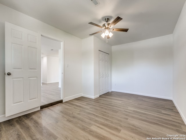 spare room with light hardwood / wood-style flooring and ceiling fan