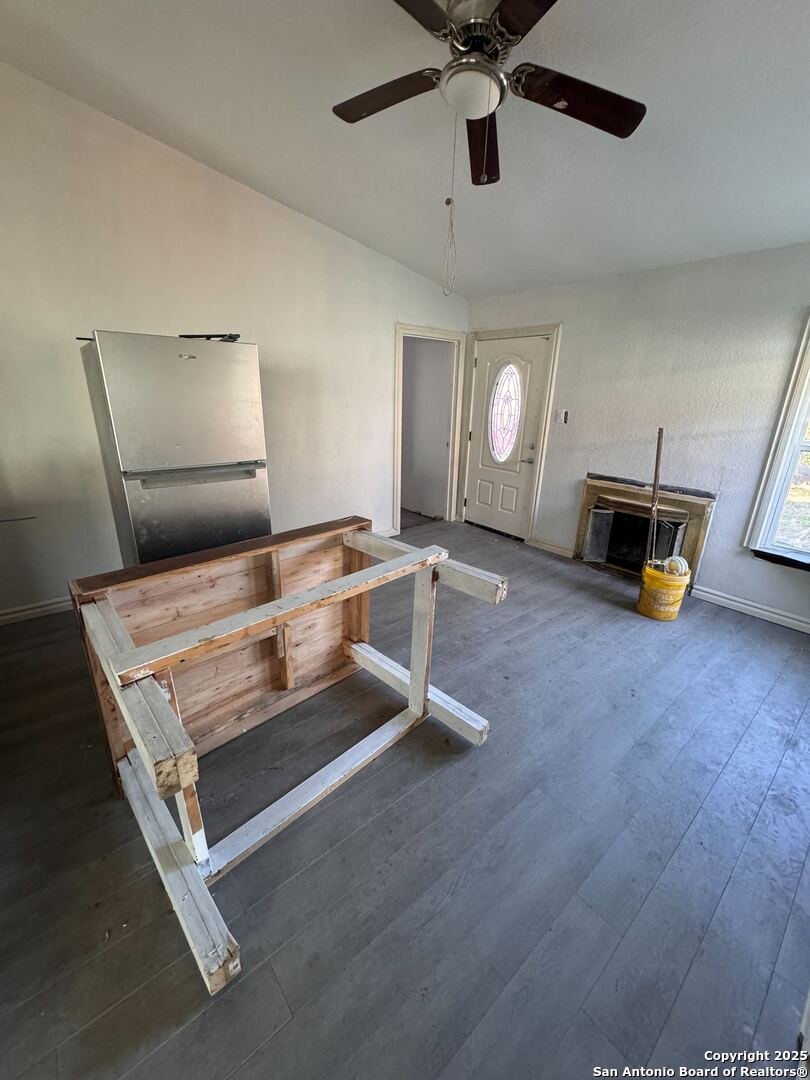 unfurnished living room with lofted ceiling and dark hardwood / wood-style floors