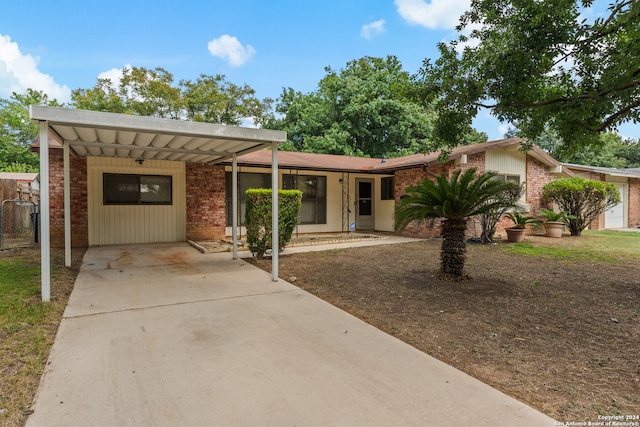 single story home featuring a carport