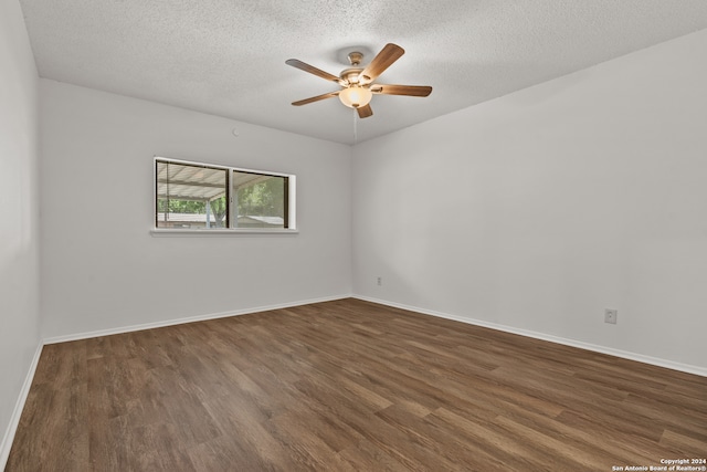 spare room with ceiling fan, a textured ceiling, and dark hardwood / wood-style flooring