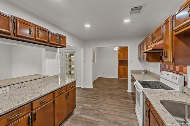 kitchen with light stone countertops, ceiling fan, hardwood / wood-style flooring, white range with electric cooktop, and sink