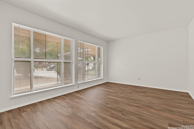 unfurnished room with wood-type flooring