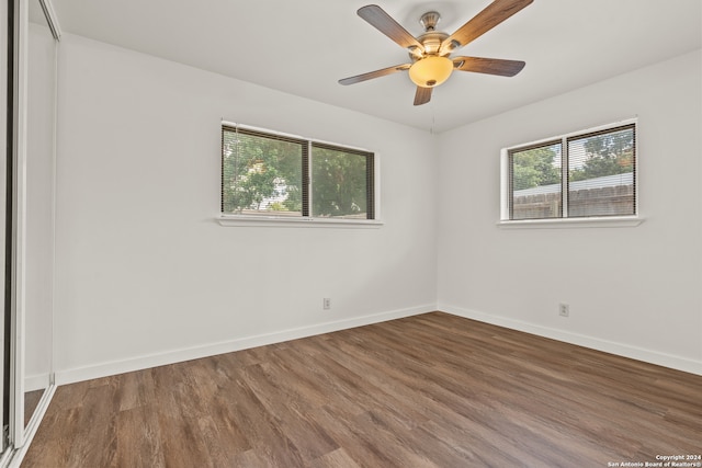 unfurnished room with ceiling fan and hardwood / wood-style flooring