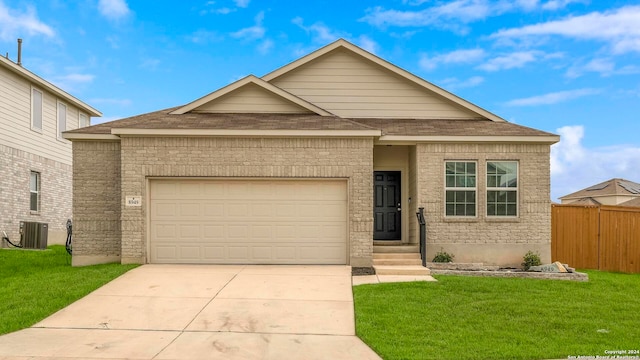 view of front facade with a front yard, central AC, and a garage