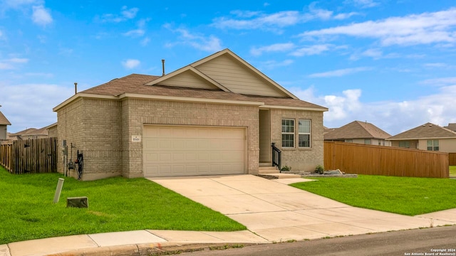 ranch-style home with a garage, fence, and a front lawn