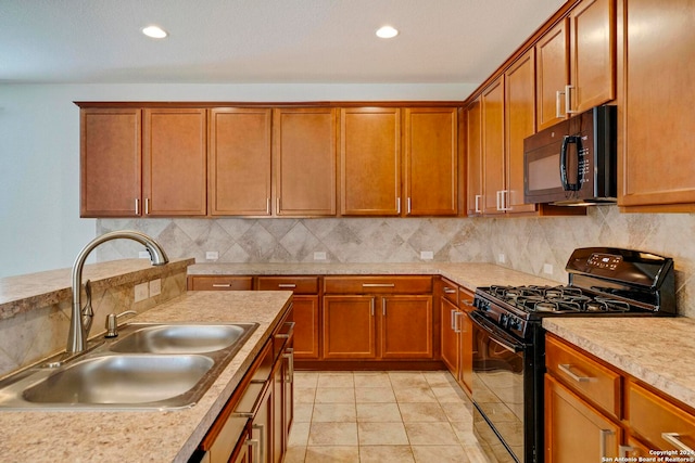 kitchen featuring a sink, light countertops, backsplash, brown cabinets, and black appliances