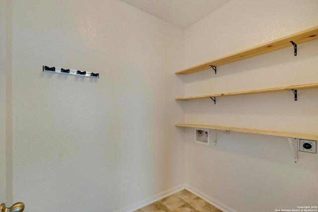 laundry area featuring laundry area, washer hookup, electric dryer hookup, and baseboards