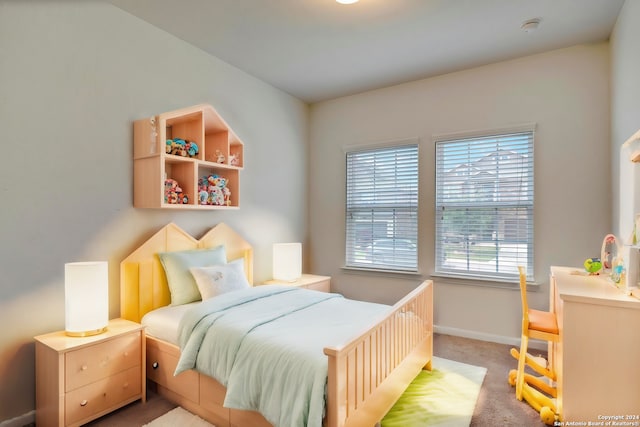 bedroom with light carpet and baseboards