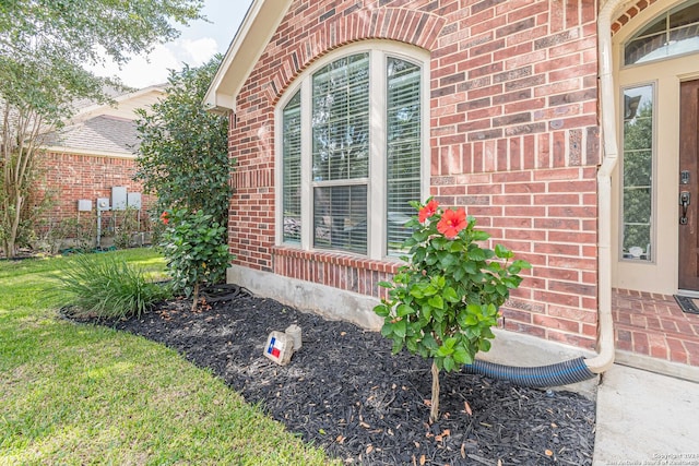 view of exterior entry with a lawn