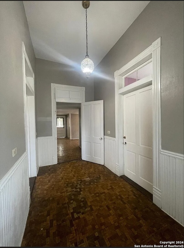 hallway with dark parquet floors