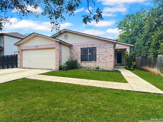 ranch-style house with a front yard and a garage