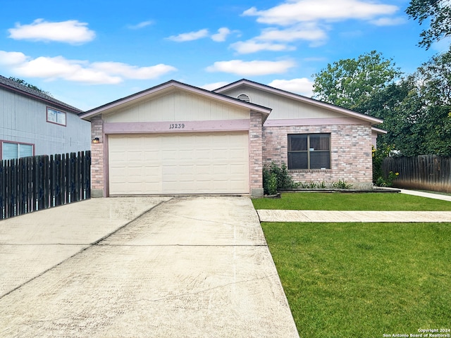 ranch-style home with a front yard and a garage